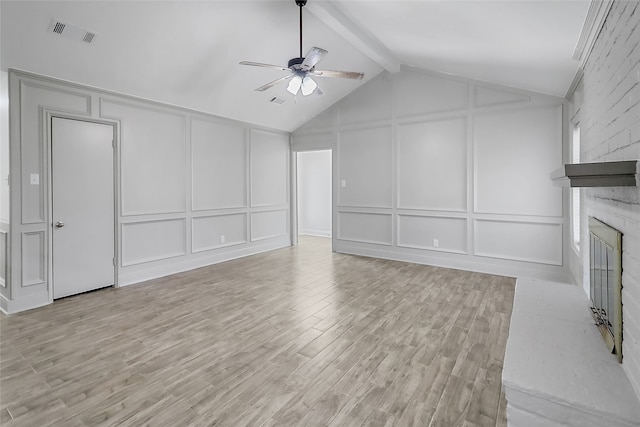 unfurnished living room featuring lofted ceiling with beams, ceiling fan, light wood-type flooring, and a fireplace