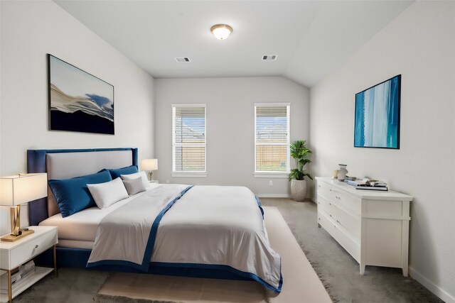 bedroom featuring light colored carpet, visible vents, vaulted ceiling, and baseboards