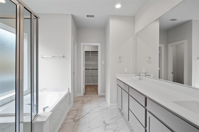 full bathroom with marble finish floor, baseboards, visible vents, and a sink