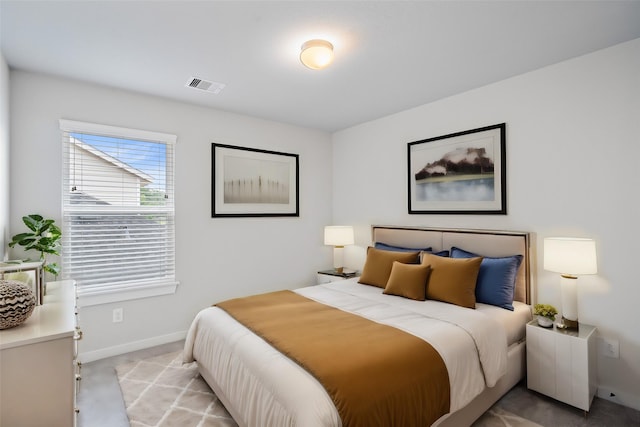 bedroom with baseboards, visible vents, and light colored carpet