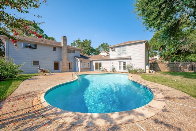 view of pool with a lawn and a patio