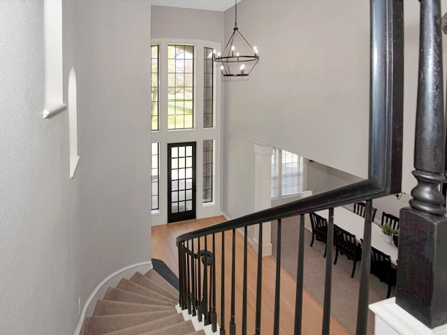 staircase featuring a notable chandelier and hardwood / wood-style flooring