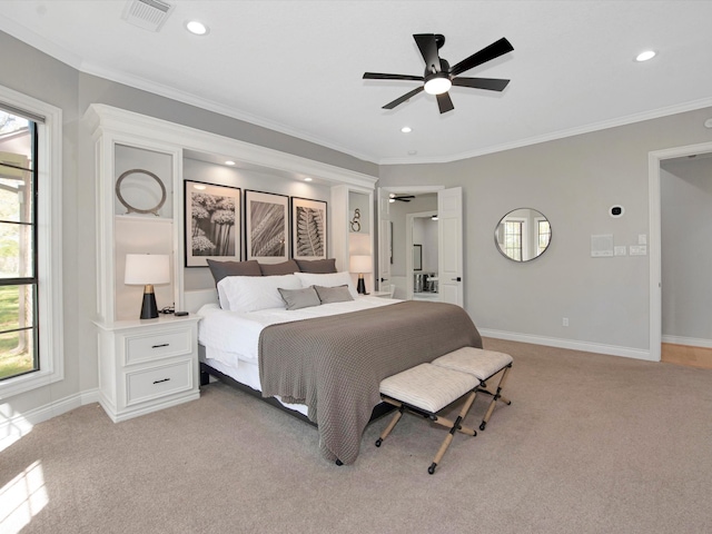 carpeted bedroom featuring ceiling fan and crown molding