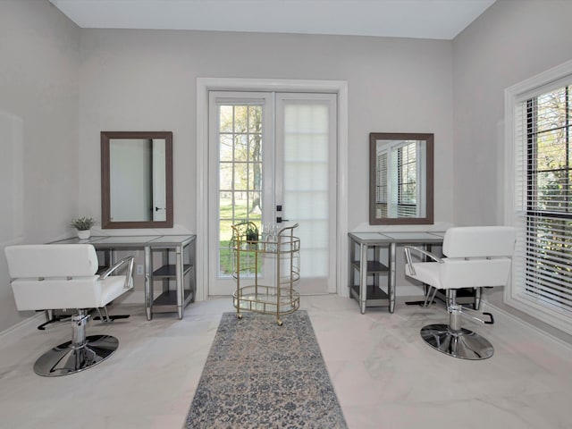 living area with french doors and light tile patterned floors