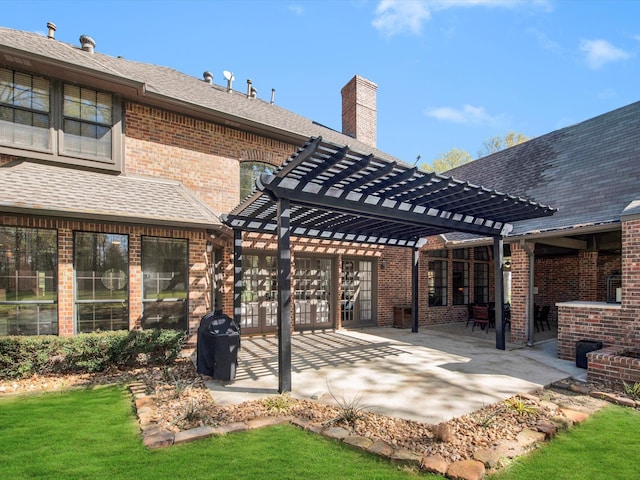 rear view of property featuring a patio area, a pergola, and a lawn