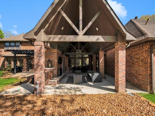 rear view of property featuring an outdoor living space and a patio