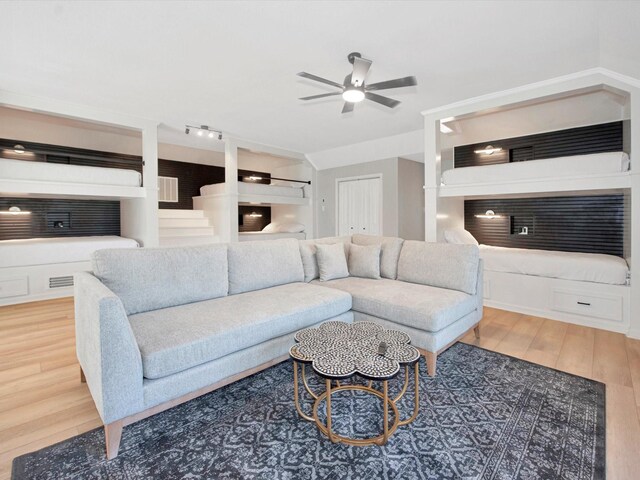 living room with ceiling fan and hardwood / wood-style flooring