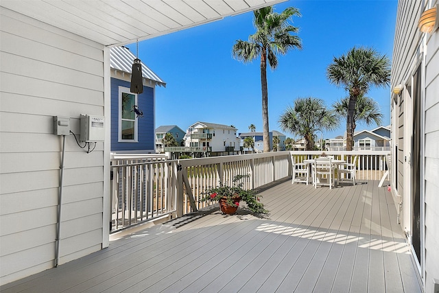 deck featuring outdoor dining area and a residential view