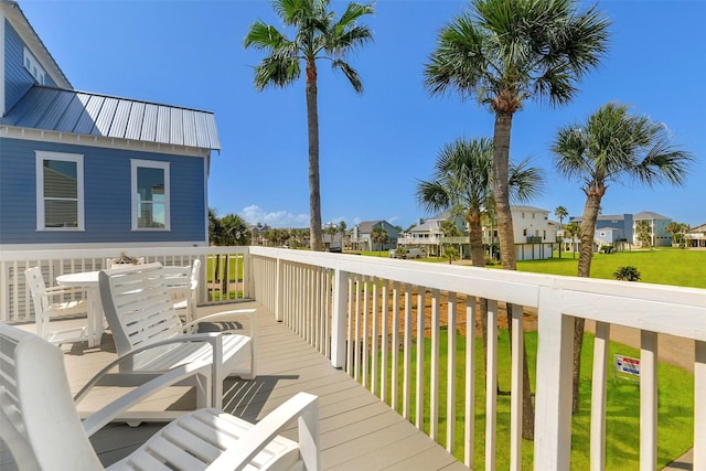 wooden deck featuring a lawn and a residential view