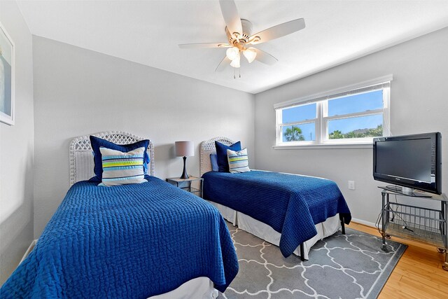 bedroom with ceiling fan and wood-type flooring