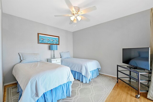 bedroom with ceiling fan and light hardwood / wood-style floors