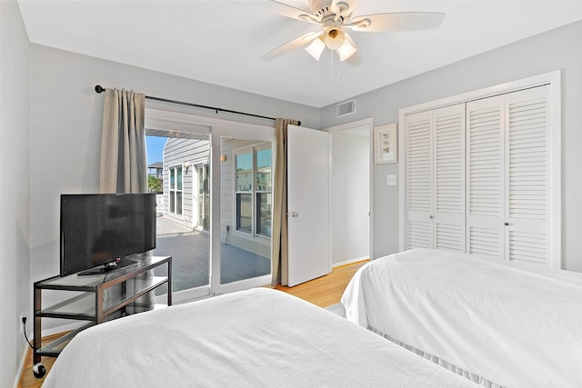 bedroom featuring ceiling fan, access to outside, light hardwood / wood-style flooring, and a closet