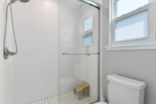 bathroom featuring toilet and walk in shower