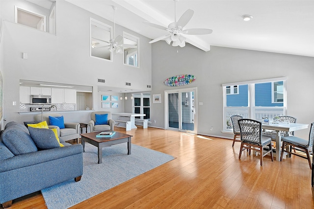 living area featuring plenty of natural light, visible vents, ceiling fan, and light wood-style flooring