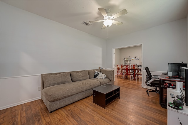 living room featuring light hardwood / wood-style flooring and ceiling fan