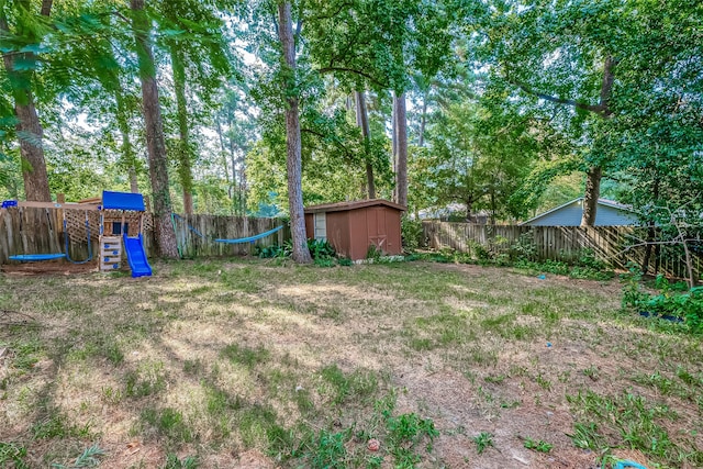 view of yard with a shed and a playground