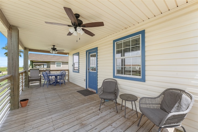 wooden terrace featuring ceiling fan