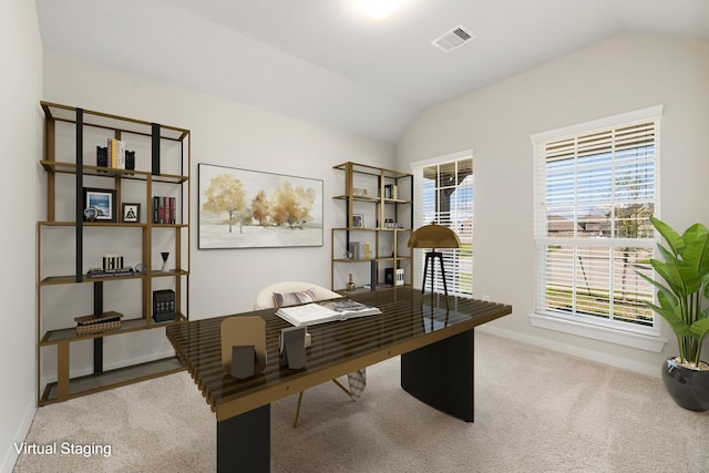 carpeted home office with lofted ceiling