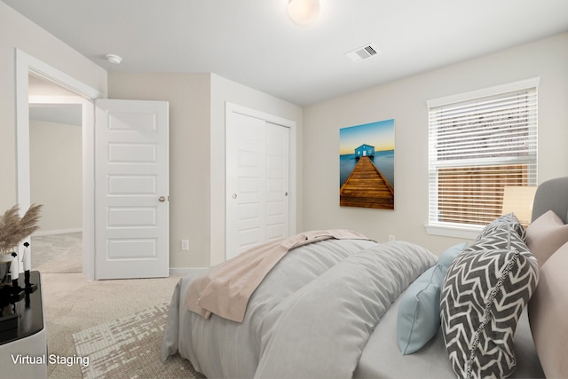 bedroom with light colored carpet and a closet