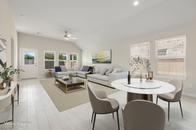 living room featuring light hardwood / wood-style floors, ceiling fan, and vaulted ceiling