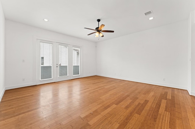 empty room featuring ceiling fan, french doors, and light hardwood / wood-style floors