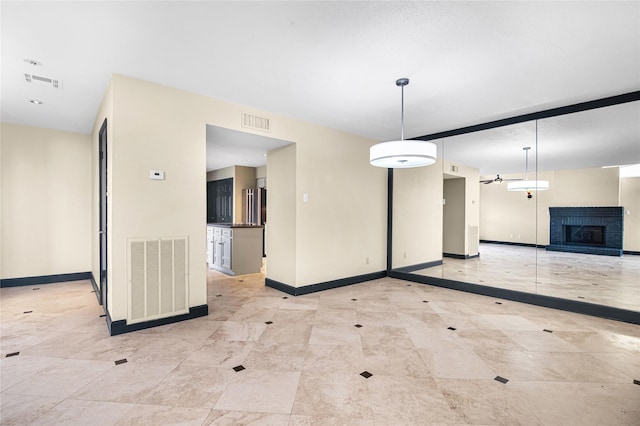 interior space with ceiling fan and a fireplace