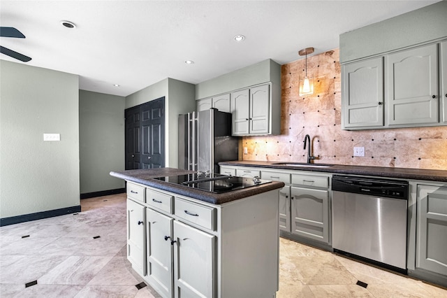 kitchen with sink, a center island, stainless steel appliances, pendant lighting, and decorative backsplash