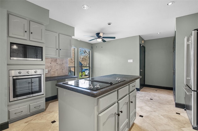 kitchen featuring gray cabinetry, ceiling fan, a center island, and appliances with stainless steel finishes