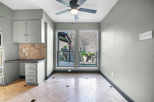 kitchen with decorative backsplash, a wealth of natural light, and ceiling fan