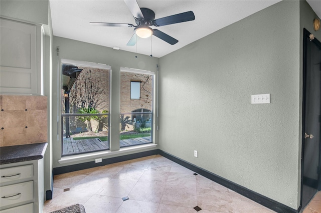 interior space featuring ceiling fan