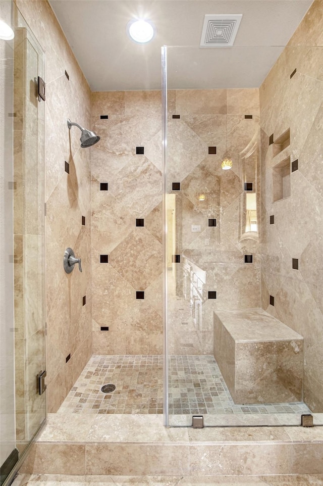 bathroom with a shower with shower door