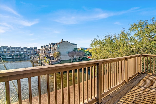 wooden terrace featuring a water view