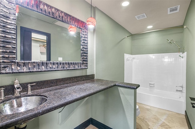 full bathroom with toilet, tiled shower / bath, and sink