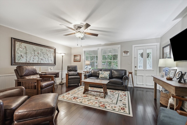 living room with ceiling fan and dark hardwood / wood-style floors