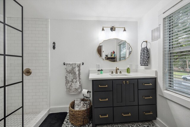 bathroom featuring a tile shower and vanity