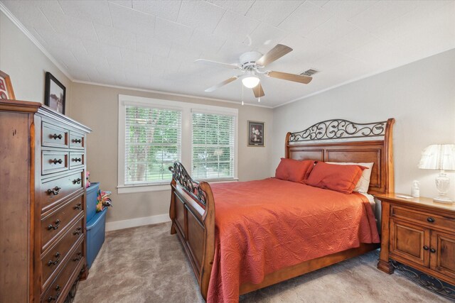 bedroom featuring ceiling fan, crown molding, and light carpet