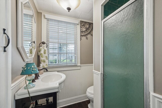 bathroom featuring toilet, walk in shower, and vanity