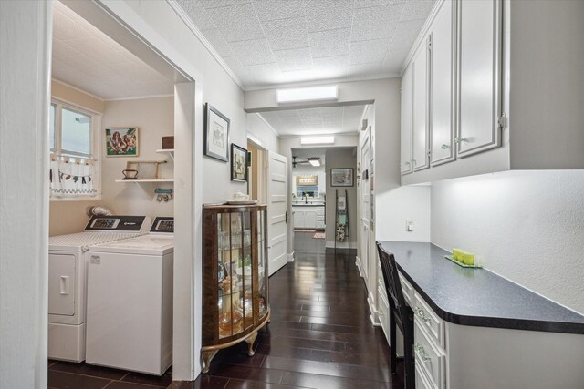 interior space featuring dark hardwood / wood-style flooring, washer and dryer, and ornamental molding