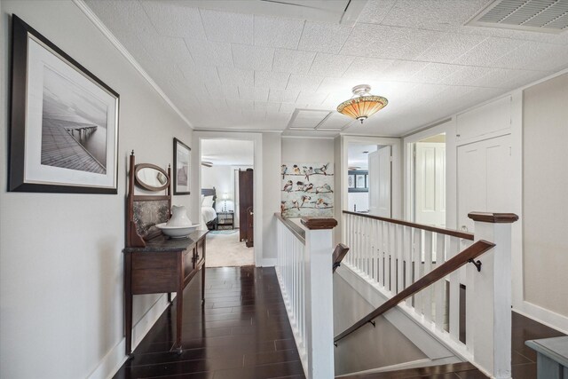 corridor featuring crown molding and dark wood-type flooring