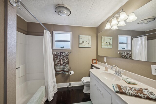 full bathroom with hardwood / wood-style flooring, plenty of natural light, vanity, and toilet