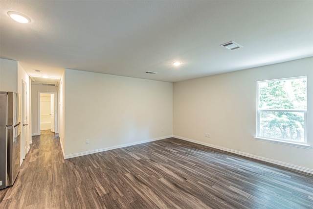 spare room with dark hardwood / wood-style floors