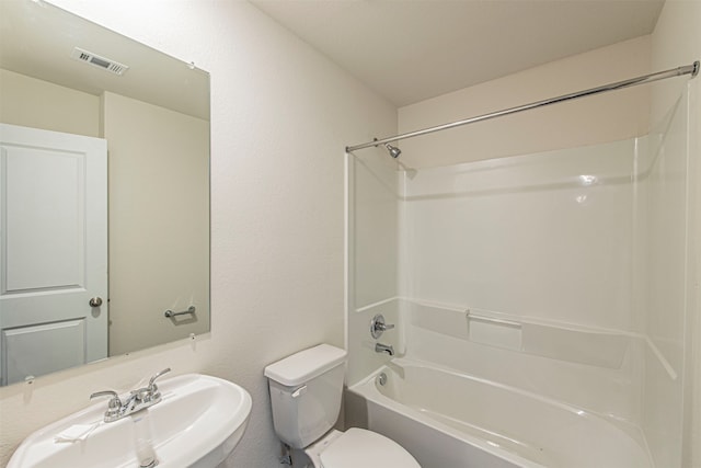 full bathroom featuring sink, shower / bath combination, and toilet