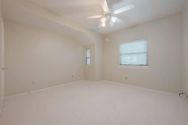 unfurnished room with ceiling fan, carpet floors, and lofted ceiling