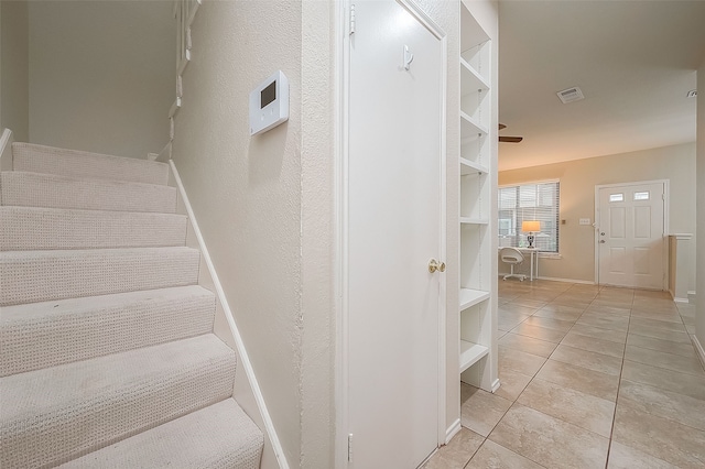 stairs featuring tile patterned flooring