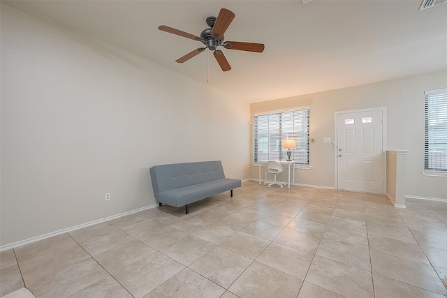 unfurnished room with ceiling fan and light tile patterned floors