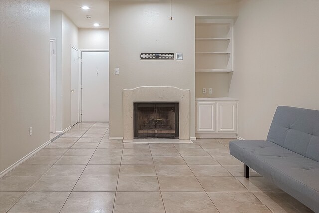 living room with built in features and light tile patterned floors