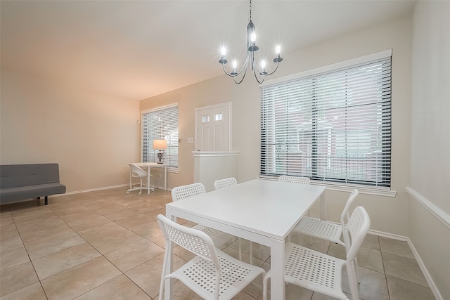 dining area with a chandelier and light tile patterned floors