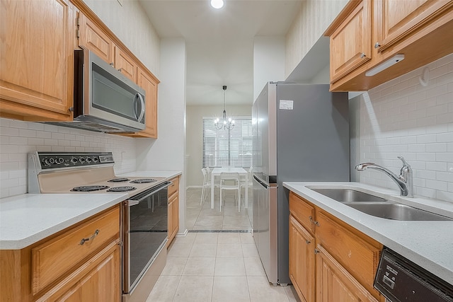 kitchen featuring backsplash, light tile patterned floors, sink, an inviting chandelier, and stainless steel appliances