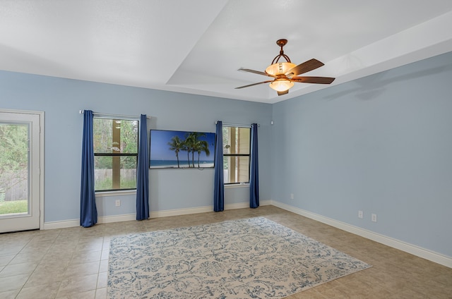 tiled spare room featuring ceiling fan