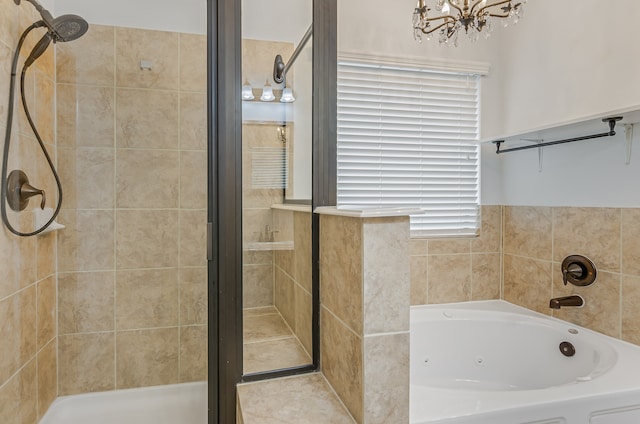 bathroom featuring an inviting chandelier and separate shower and tub